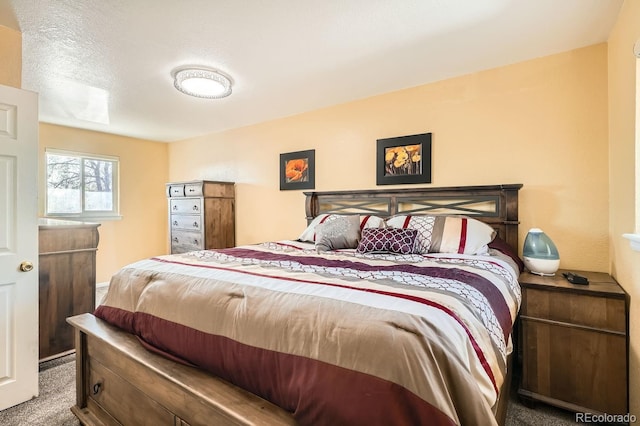 carpeted bedroom featuring a textured ceiling