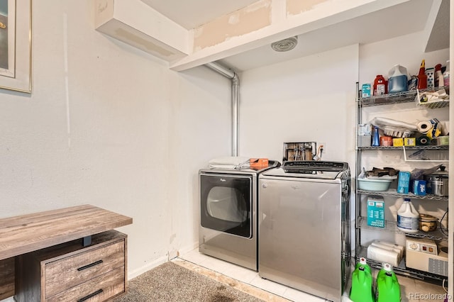 laundry room featuring light tile patterned flooring and washing machine and clothes dryer