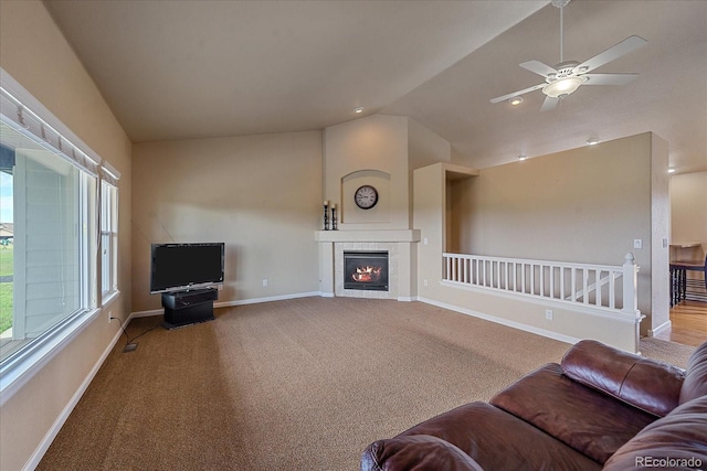 carpeted living room featuring vaulted ceiling and ceiling fan