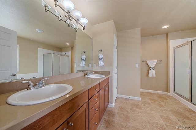 bathroom with vanity and a shower with shower door