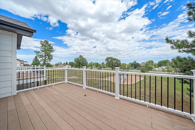 wooden terrace featuring a lawn