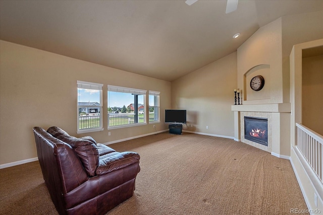 living room with carpet, lofted ceiling, and a tiled fireplace