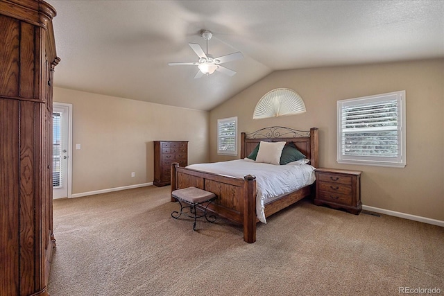 carpeted bedroom with ceiling fan, vaulted ceiling, and multiple windows