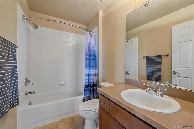 full bathroom featuring tile patterned floors, a textured ceiling, toilet, vanity, and shower / tub combo