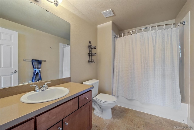 full bathroom featuring shower / bath combo, tile patterned floors, vanity, a textured ceiling, and toilet