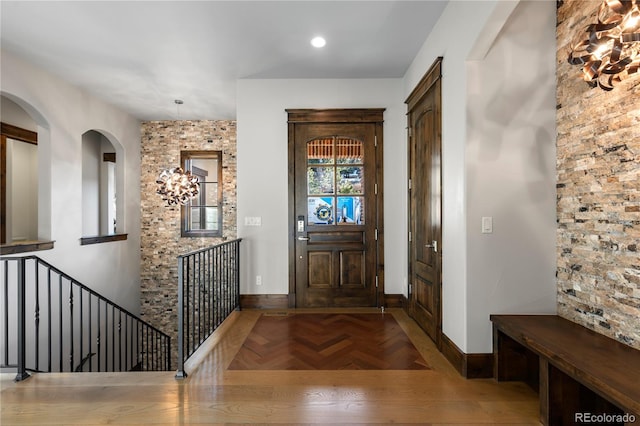 foyer featuring parquet flooring and baseboards