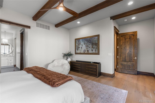 bedroom featuring beam ceiling, hardwood / wood-style flooring, visible vents, and baseboards