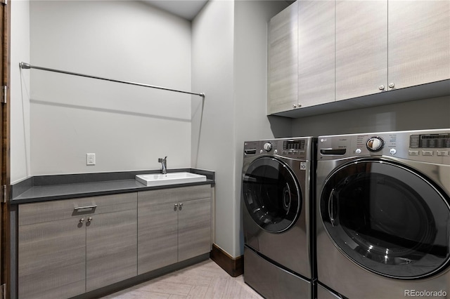 laundry area featuring independent washer and dryer, a sink, and cabinet space