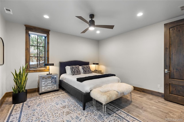 bedroom featuring wood finished floors, visible vents, and recessed lighting