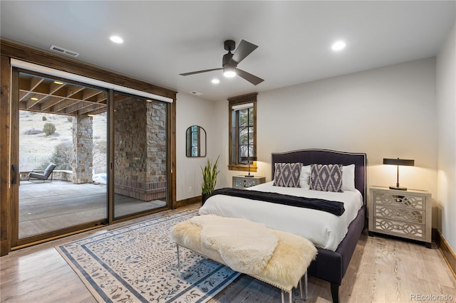 bedroom with recessed lighting, wood finished floors, visible vents, baseboards, and access to outside