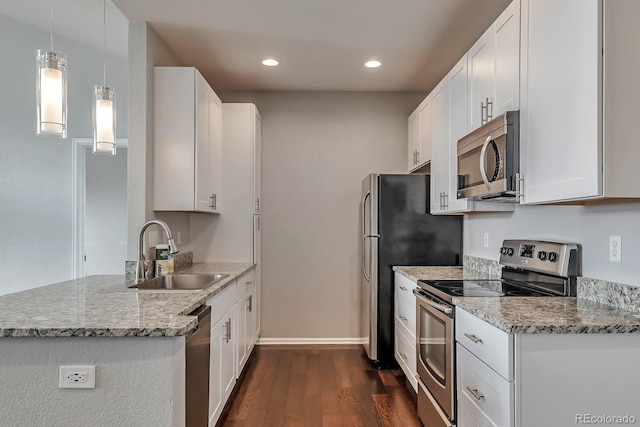 14251 E 1st Dr Unit 308, Aurora, CO 80011 - kitchen with stainless steel appliances, a sink, dark wood-type flooring, baseboards, and light stone countertops