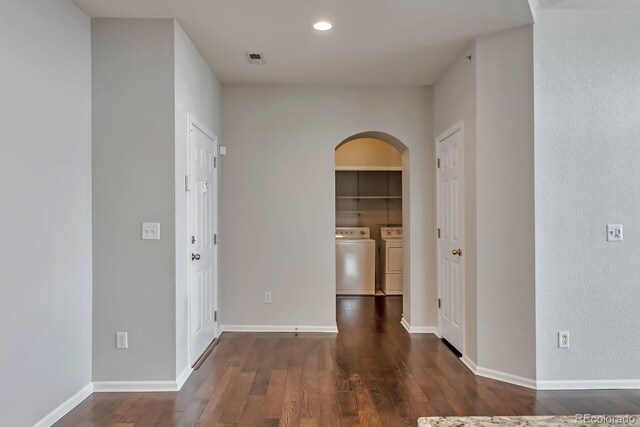 14251 E 1st Dr Unit 308, Aurora, CO 80011 - unfurnished room with washing machine and dryer, arched walkways, wood finished floors, recessed lighting, and baseboards