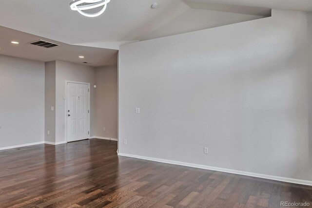 14251 E 1st Dr Unit 308, Aurora, CO 80011 - spare room with dark wood finished floors, baseboards, recessed lighting, and vaulted ceiling