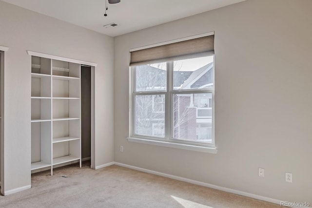 14251 E 1st Dr Unit 308, Aurora, CO 80011 - unfurnished bedroom featuring carpet flooring, multiple windows, and baseboards