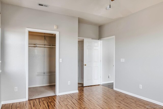 14251 E 1st Dr Unit 308, Aurora, CO 80011 - unfurnished bedroom featuring wood finished floors, baseboards, and a closet