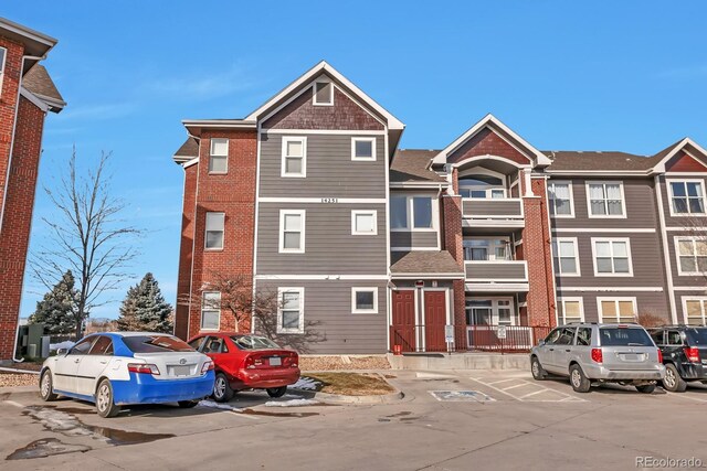 14251 E 1st Dr Unit 308, Aurora, CO 80011 - view of front of home featuring uncovered parking