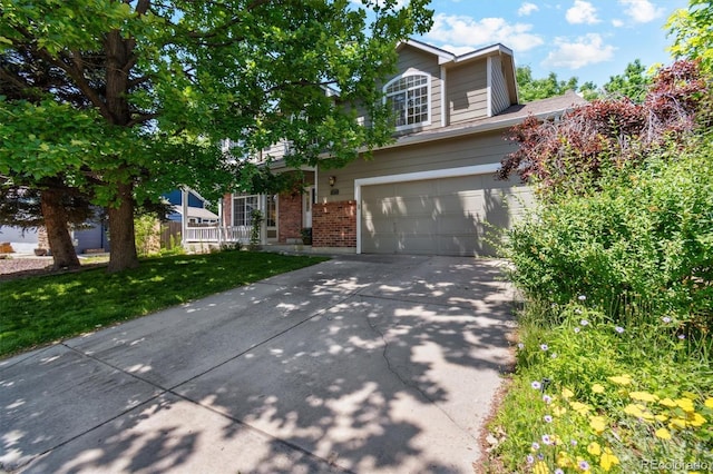 5625 W 109th Cir, Westminster, CO 80020 - view of property hidden behind natural elements featuring brick siding, concrete driveway, and an attached garage