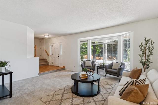 5625 W 109th Cir, Westminster, CO 80020 - carpeted living room with a textured ceiling and stairway