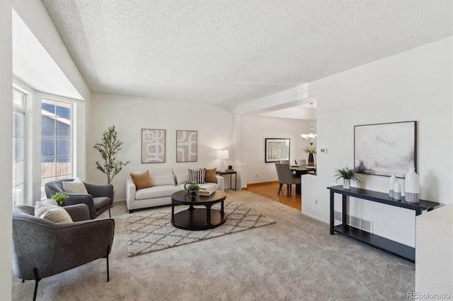5625 W 109th Cir, Westminster, CO 80020 - carpeted living room with a textured ceiling and a chandelier