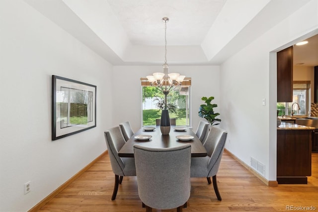 5625 W 109th Cir, Westminster, CO 80020 - dining room featuring a chandelier, light wood finished floors, and a tray ceiling