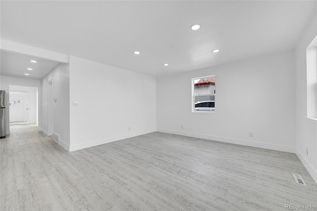 spare room featuring light wood-type flooring