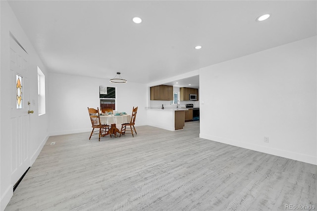 dining area featuring sink and light wood-type flooring