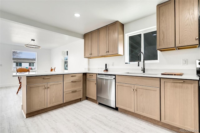 kitchen with sink, light hardwood / wood-style flooring, stainless steel dishwasher, and kitchen peninsula