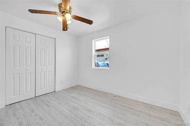 unfurnished bedroom with a closet, ceiling fan, and light wood-type flooring