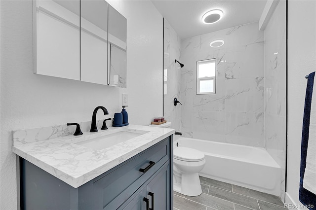 full bathroom with tiled shower / bath combo, vanity, and toilet