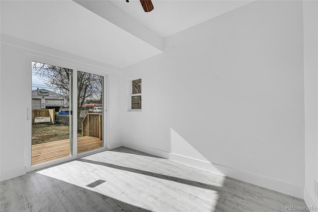 empty room with ceiling fan and light wood-type flooring