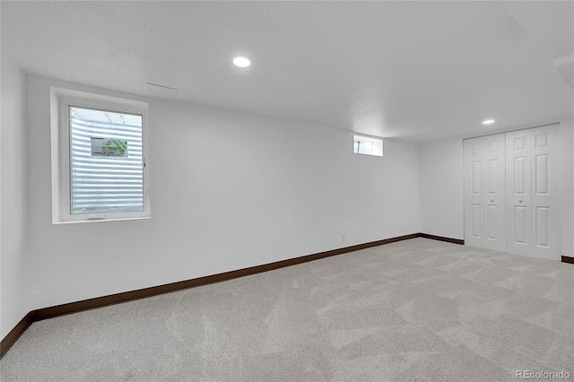 basement featuring light carpet