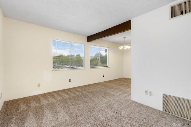 unfurnished room with beamed ceiling, a textured ceiling, a chandelier, and carpet floors