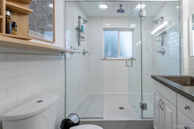 4891 Depew St, Denver, CO 80212 - full bath with tile walls, a shower stall, vanity, and tile patterned floors