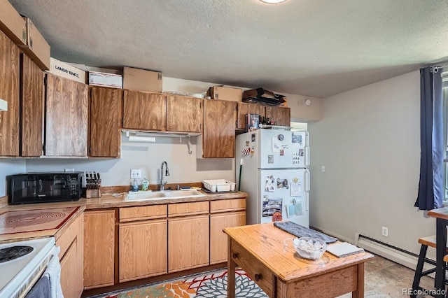 kitchen featuring a textured ceiling, white appliances, a baseboard radiator, and sink