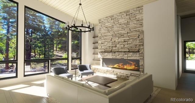 7142 Lynx Lair Rd, Evergreen, CO 80439 - living area with a chandelier and a fireplace