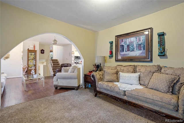4345 S Chamberlin, Colorado Springs, CO 80906 - living area featuring arched walkways, stairs, and wood finished floors