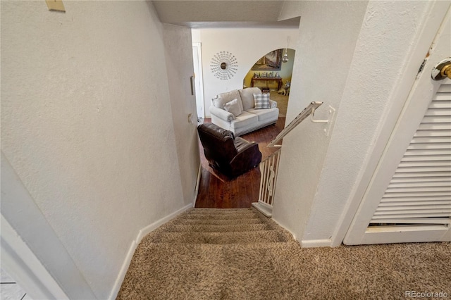 4345 S Chamberlin, Colorado Springs, CO 80906 - stairs featuring carpet floors, arched walkways, a textured wall, and baseboards