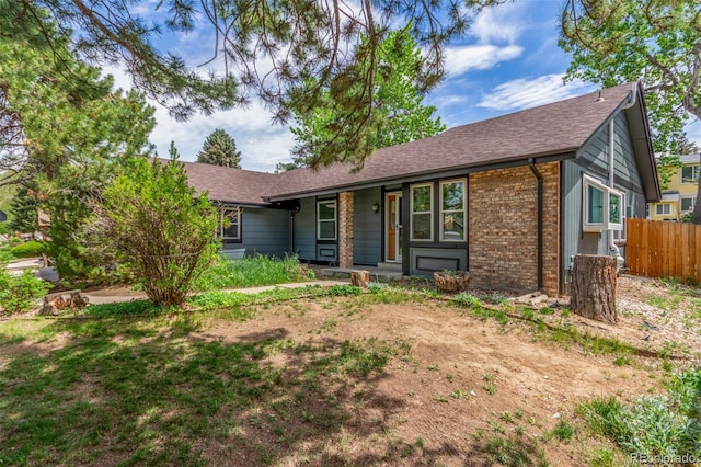 2026 S Pitkin St, Aurora, CO 80013 - ranch-style home featuring fence, brick siding, a shingled roof, and covered porch
