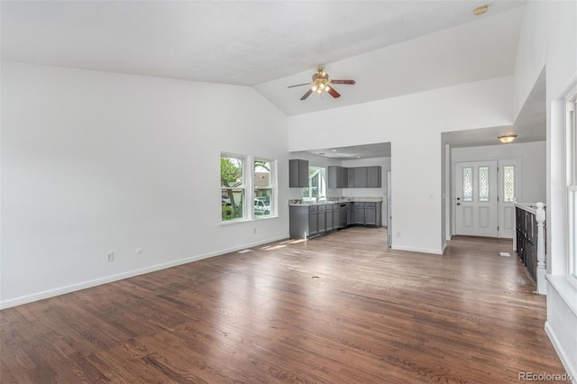 2026 S Pitkin St, Aurora, CO 80013 - unfurnished living room with a ceiling fan, baseboards, wood finished floors, and high vaulted ceiling