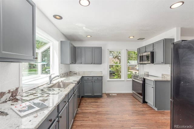 2026 S Pitkin St, Aurora, CO 80013 - kitchen with appliances with stainless steel finishes, gray cabinetry, healthy amount of natural light, and recessed lighting