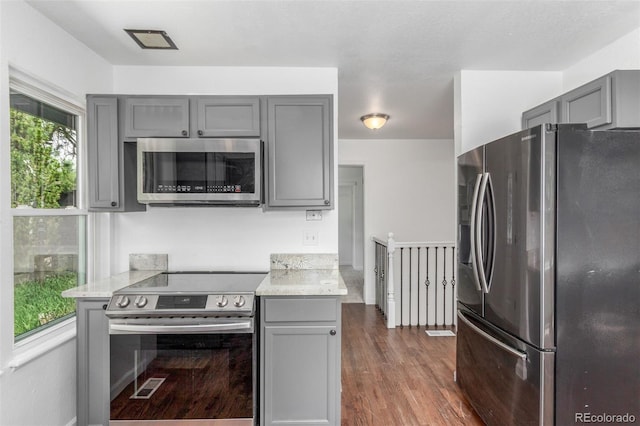 2026 S Pitkin St, Aurora, CO 80013 - kitchen with stainless steel appliances, gray cabinetry, and dark wood-style floors