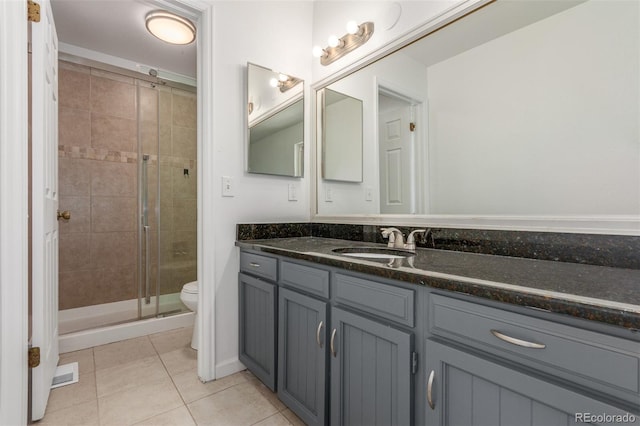 2026 S Pitkin St, Aurora, CO 80013 - bathroom featuring a stall shower, tile patterned flooring, toilet, and vanity