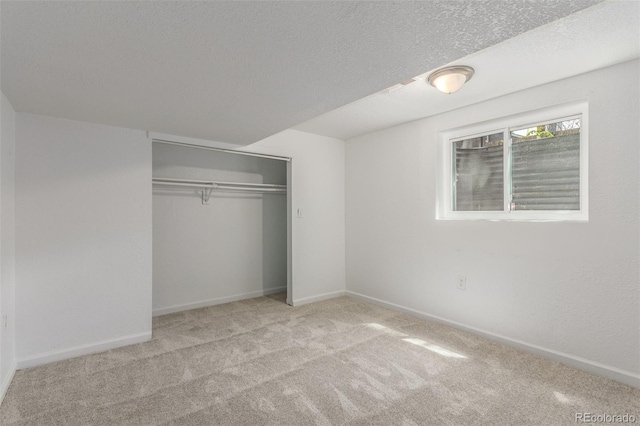 2026 S Pitkin St, Aurora, CO 80013 - unfurnished bedroom featuring carpet flooring, a closet, baseboards, and a textured ceiling