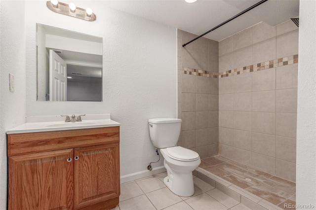 2026 S Pitkin St, Aurora, CO 80013 - full bathroom with toilet, a tile shower, tile patterned floors, vanity, and baseboards