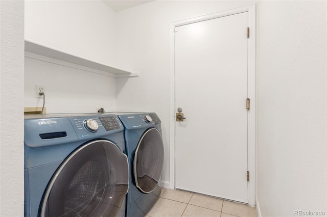 2026 S Pitkin St, Aurora, CO 80013 - clothes washing area with washing machine and dryer, light tile patterned floors, and baseboards