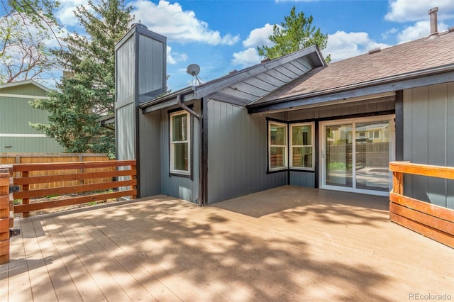 2026 S Pitkin St, Aurora, CO 80013 - rear view of house with a chimney, a wooden deck, and roof with shingles