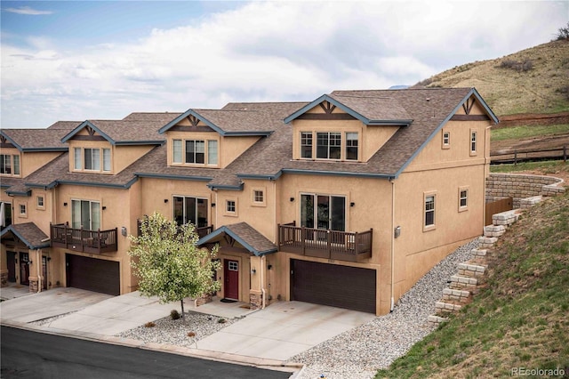 5703 Canyon Reserve Hts, Colorado Springs, CO 80919 - view of front of home with roof with shingles, an attached garage, concrete driveway, and stucco siding