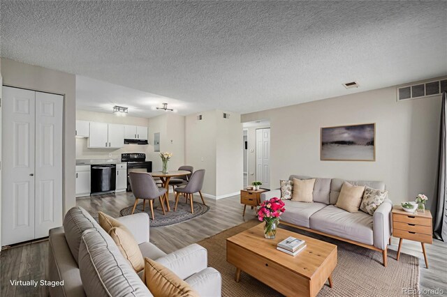 8843 Colorado Blvd Unit 208, Thornton, CO 80229 - living area featuring wood finished floors, electric panel, and a textured ceiling