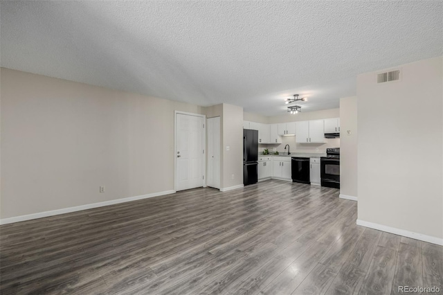 8843 Colorado Blvd Unit 208, Thornton, CO 80229 - unfurnished living room with dark wood-style flooring and a textured ceiling