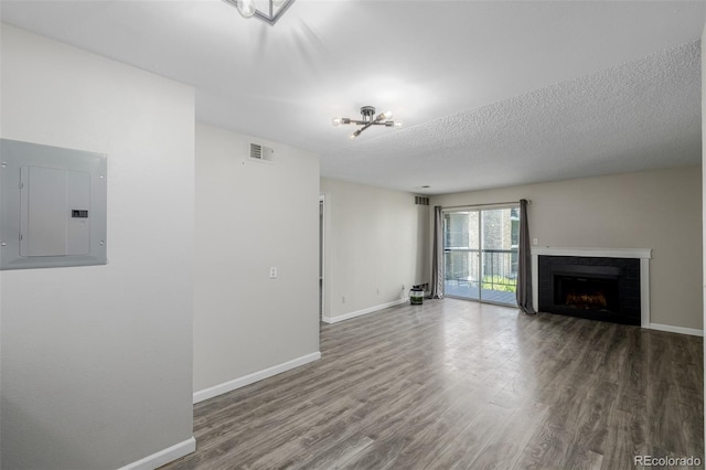 8843 Colorado Blvd Unit 208, Thornton, CO 80229 - unfurnished living room with electric panel, wood finished floors, a chandelier, and a fireplace